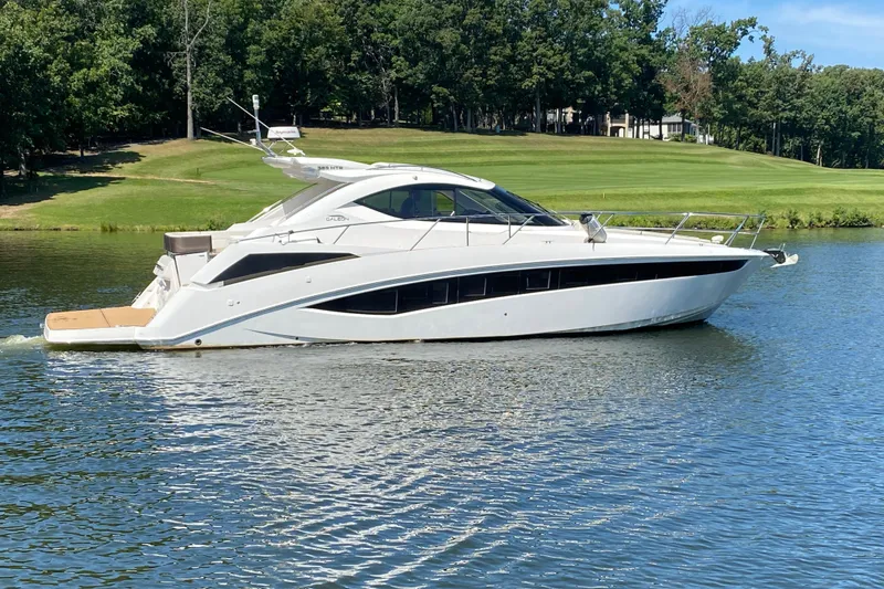Slide: The Image of 2018 Galeon 385 HTS yacht cruising on a serene lake surrounded by lush greenery. - 7