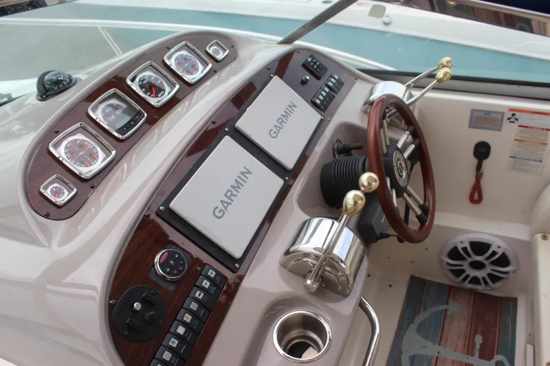 Slide: The Image of 2008 Chaparral Signature 350 boat dashboard with Garmin navigation and wood accents. - 24
