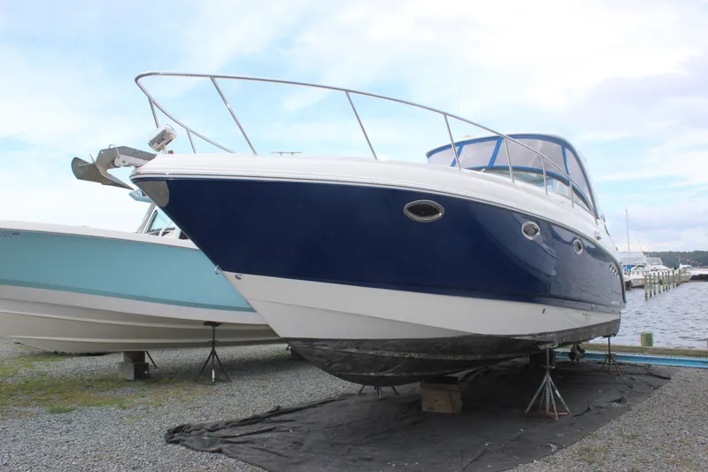 Slide: The Image of 2008 Chaparral Signature 350 boat on dry dock, blue and white hull, marina background. - 3