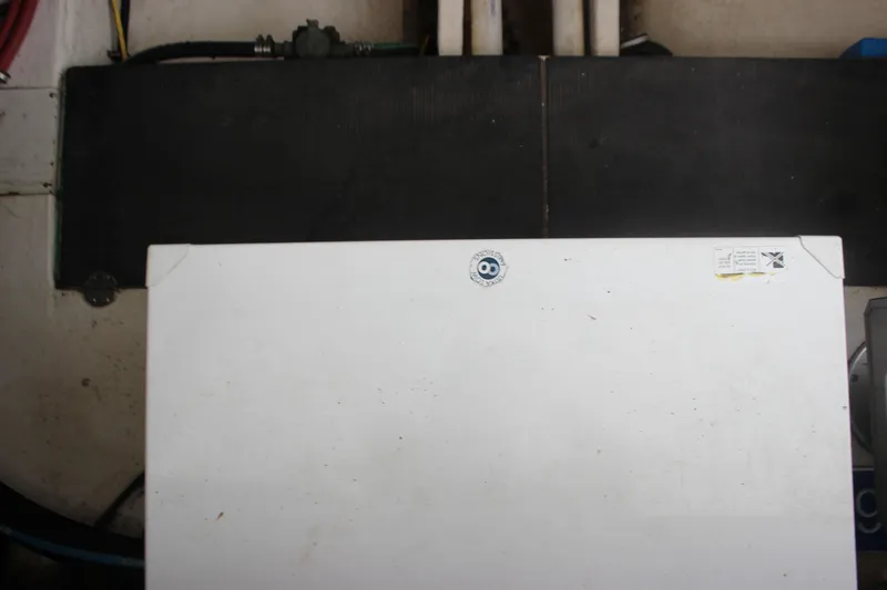 Slide: The Image of Engine compartment of a 2008 Chaparral Signature 350 boat, featuring a white panel. - 31