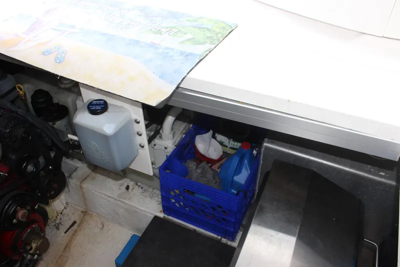 Slide: The Image of Engine compartment of 2008 Chaparral Signature 350 with storage and maintenance supplies. - 33