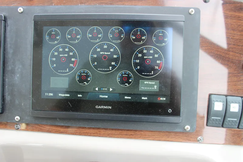 Slide: The Image of Garmin display on 2008 Chaparral Signature 350 boat dashboard showing gauges and controls. - 37