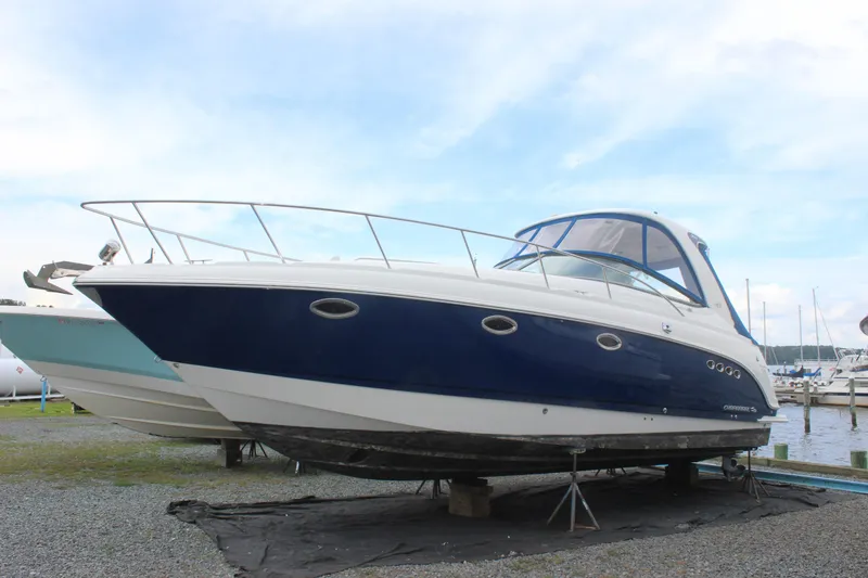 Slide: The Image of 2008 Chaparral Signature 350 boat on dry dock, blue and white exterior. - 4
