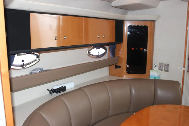 Slide: The Image of 2008 Chaparral Signature 350 interior with leather seating, wooden cabinets, and porthole windows. - 40