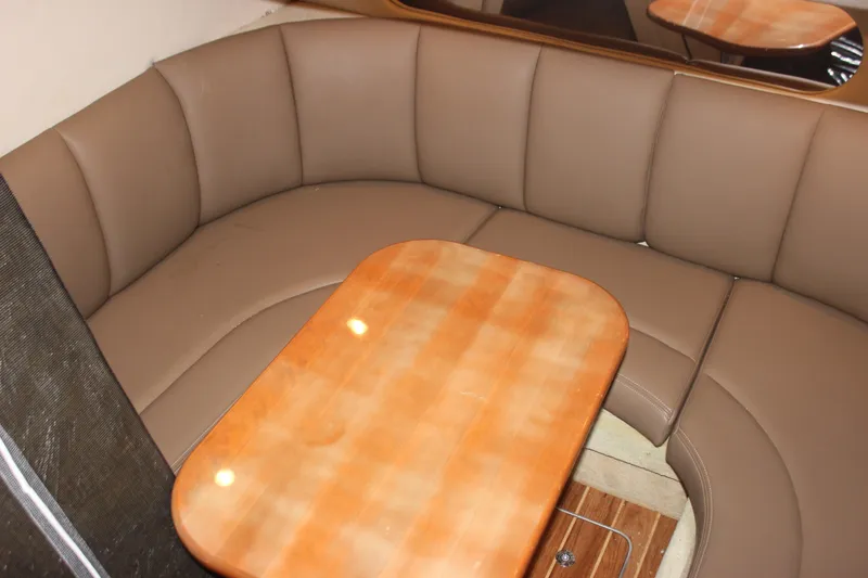 Slide: The Image of 2008 Chaparral Signature 350 interior with brown leather seating and wooden table. - 42