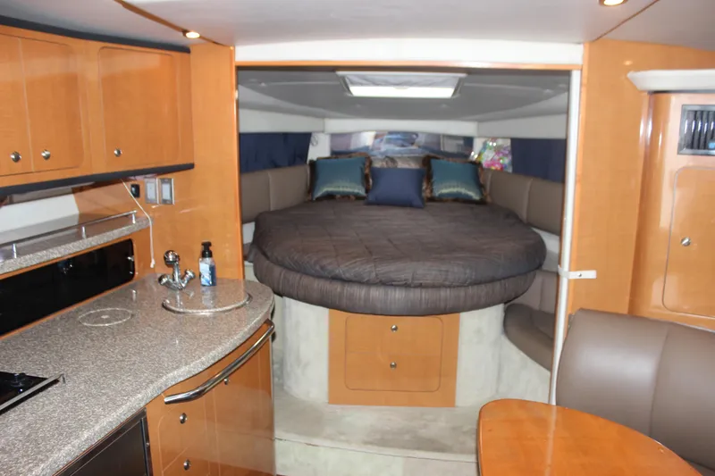 Slide: The Image of 2008 Chaparral Signature 350 interior with cozy bed, kitchenette, and seating area. - 48