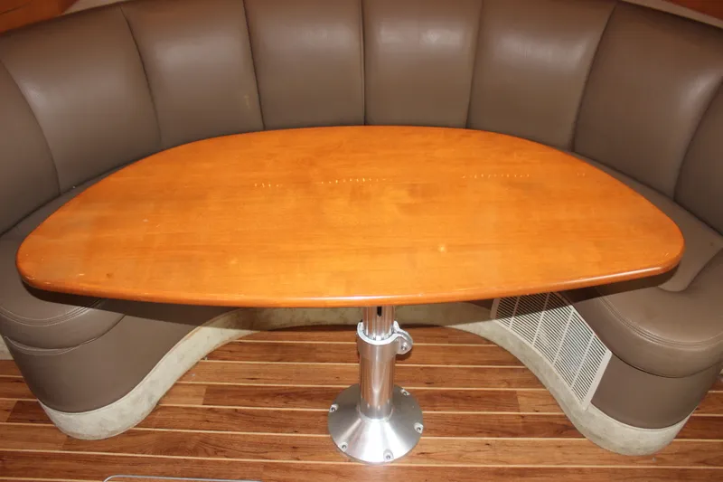 Slide: The Image of 2008 Chaparral Signature 350 interior with wooden table and curved leather seating. - 49