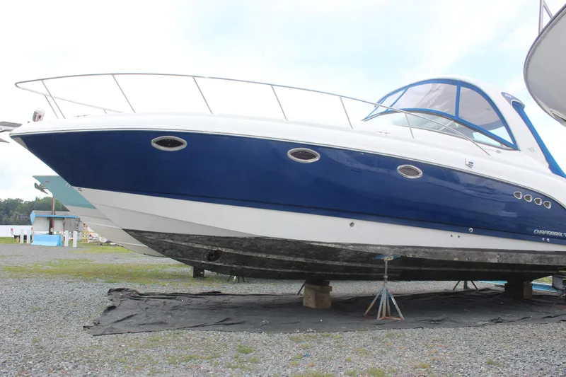 Slide: The Image of 2008 Chaparral Signature 350 boat on land, blue and white hull, side view. - 5