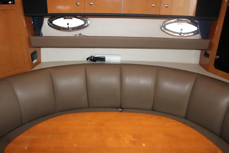 Slide: The Image of 2008 Chaparral Signature 350 interior with brown leather seating and wooden table. - 50