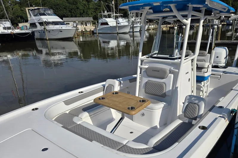 Slide: The Image of 2022 Caymas 28 HB boat docked, featuring a Minn Kota trolling motor. - 11