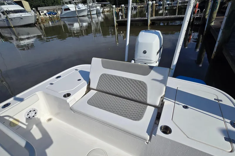 Slide: The Image of 2022 Caymas 28 HB boat cockpit with steering wheel and control panel at marina. - 16