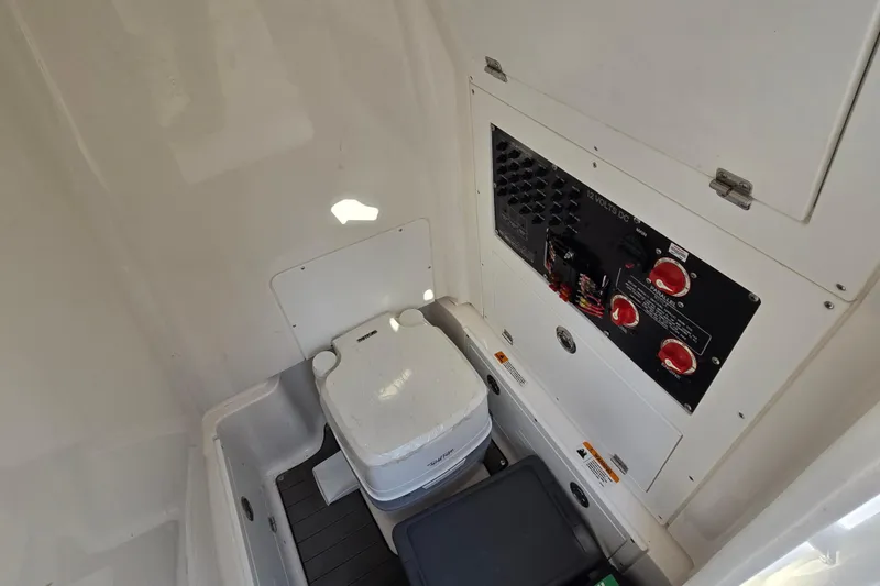 Slide: The Image of 2022 Caymas 28 HB boat interior with cushioned seating and wooden table. - 20