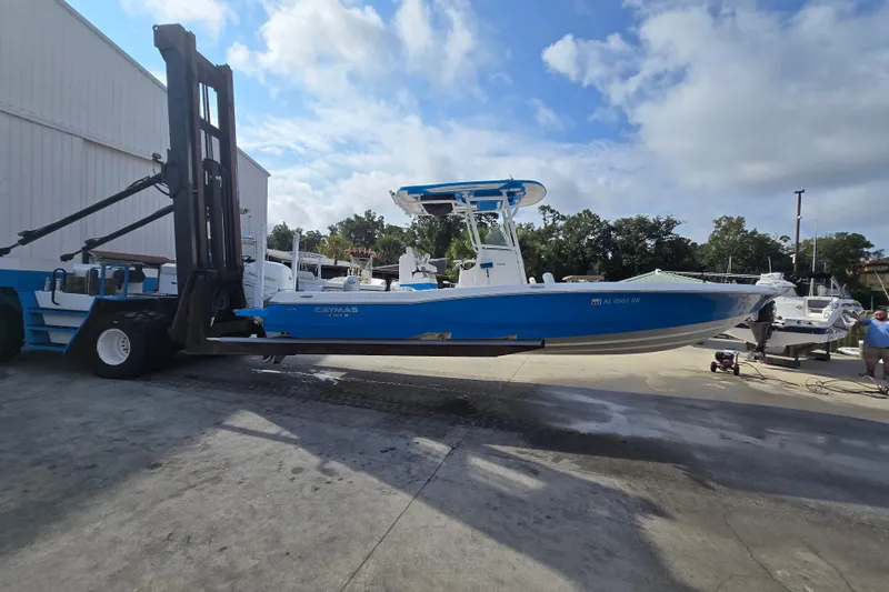 Slide: The Image of 2022 Caymas 28 HB boat docked in a marina with sailboats in the background. - 3