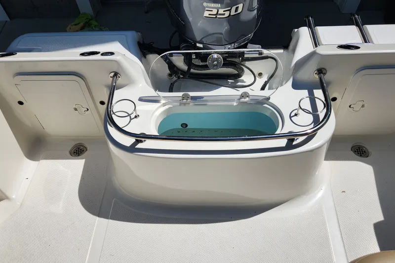 Slide: The Image of Key West 211 DC boat deck with Yamaha 250 engine, livewell, and storage compartments, 2012 model. - 10
