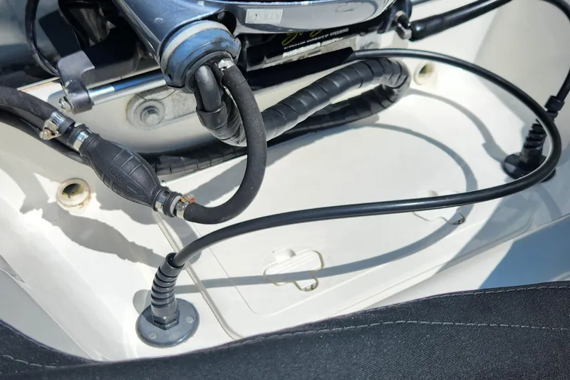Slide: The Image of Boat engine compartment of 2012 Key West 211 DC with cables and hoses. - 12