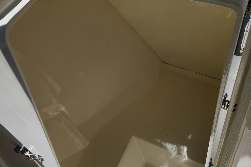 Slide: The Image of Storage compartment inside a 2012 Key West 211 DC boat, featuring a clean, spacious interior. - 16