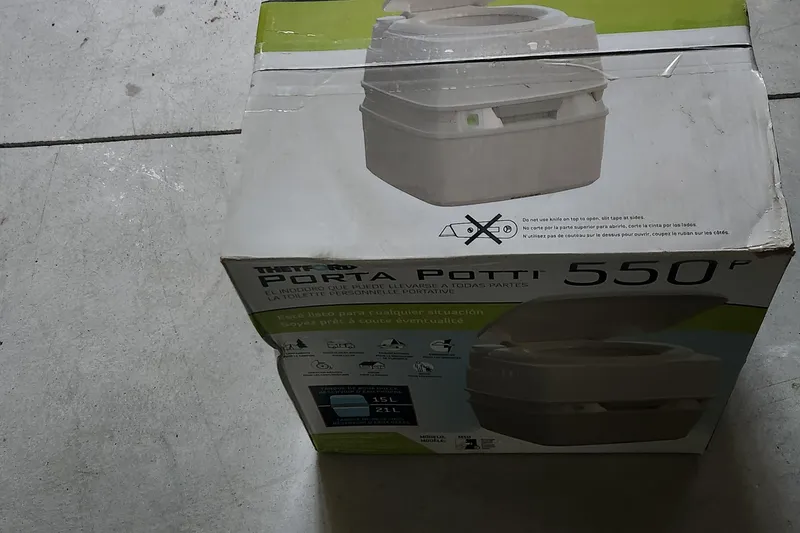 Slide: The Image of Box of Thetford Porta Potti 550P portable toilet on concrete floor. - 24