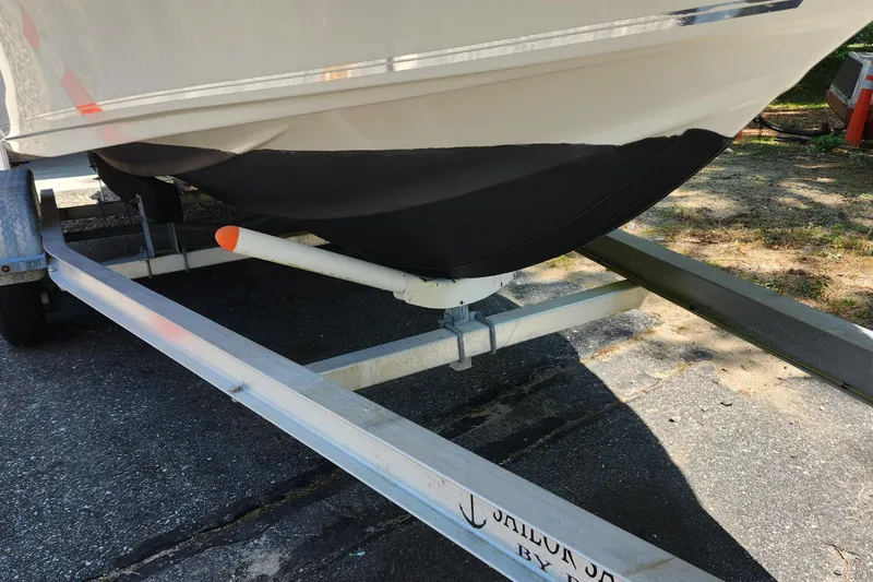 Slide: The Image of 2012 Key West 211 DC boat on trailer, black hull, parked outdoors. - 5