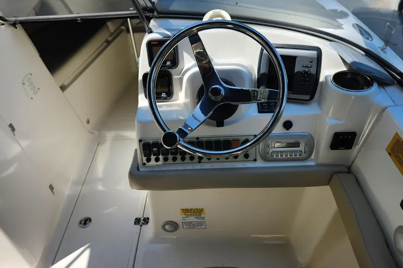 Slide: The Image of 2012 Key West 211 DC boat dashboard with steering wheel and control panel. - 7