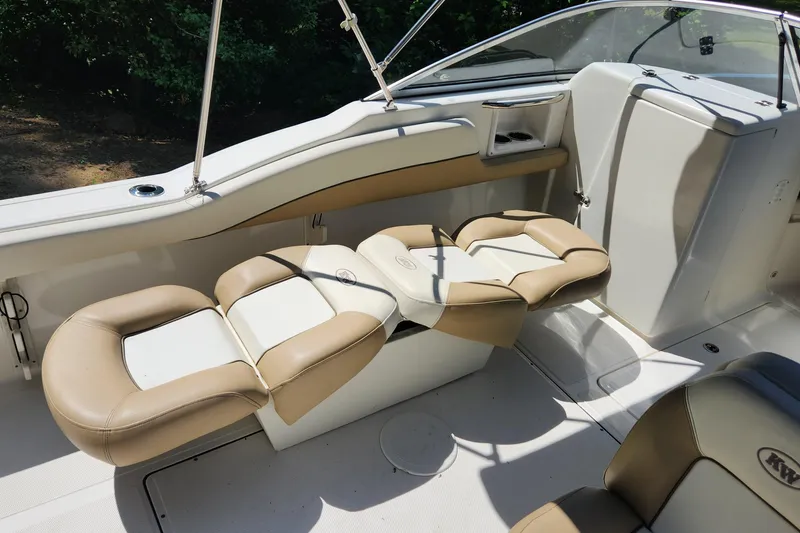 Slide: The Image of 2012 Key West 211 DC boat interior with beige and white seating. - 8