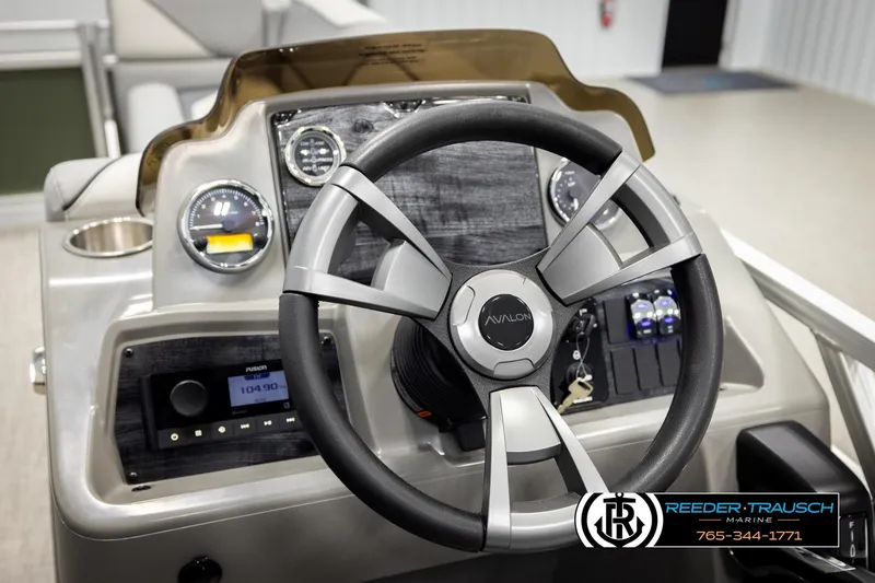Slide: The Image of Steering wheel and dashboard of 2026 Avalon VEN CRB boat, featuring modern controls. - 27