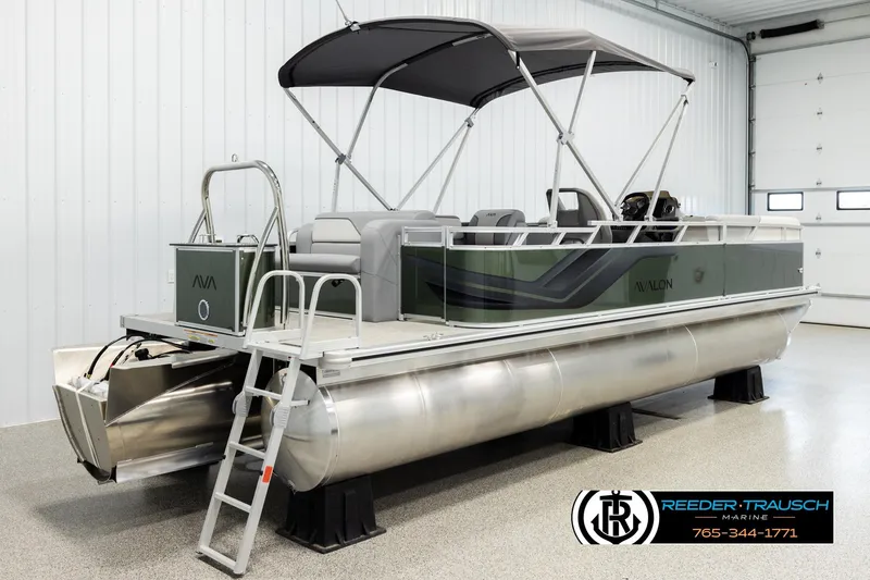 Slide: The Image of 2026 Avalon VEN CRB pontoon boat in showroom with canopy and ladder. - 5