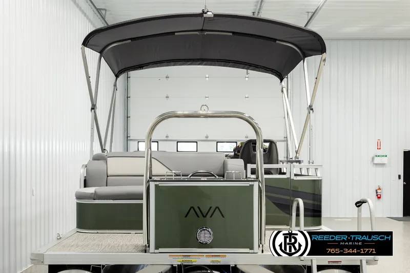 Slide: The Image of 2026 Avalon VEN CRB pontoon boat in a showroom with canopy and seating. - 6