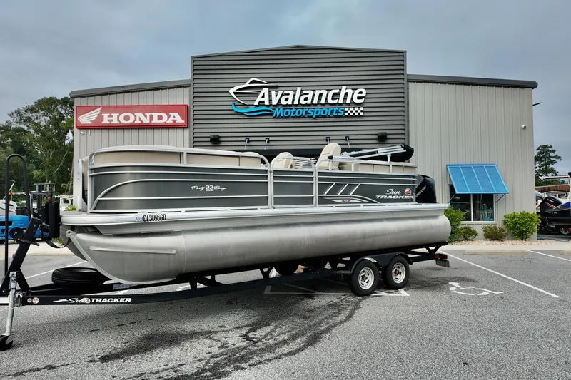 The Image of 2023 Sun Tracker Party Barge 22 DLX pontoon boat on trailer at Avalanche Motorsports. - 1