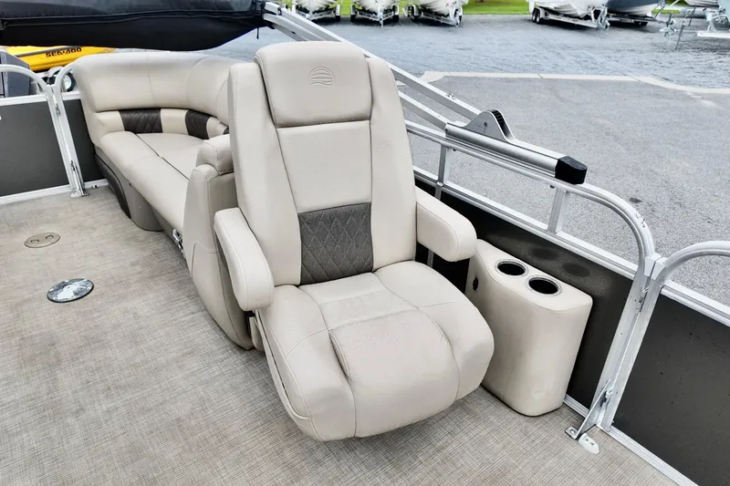 Slide: The Image of 2023 Sun Tracker Party Barge 22 DLX interior with plush seating and cup holders. - 10