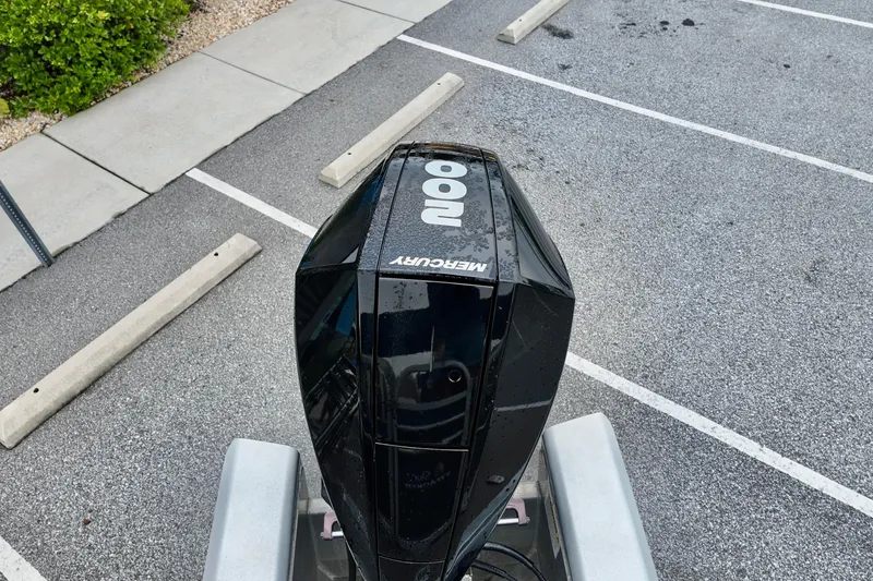 Slide: The Image of Mercury outboard motor on 2023 Sun Tracker Party Barge 22 DLX in parking lot. - 11