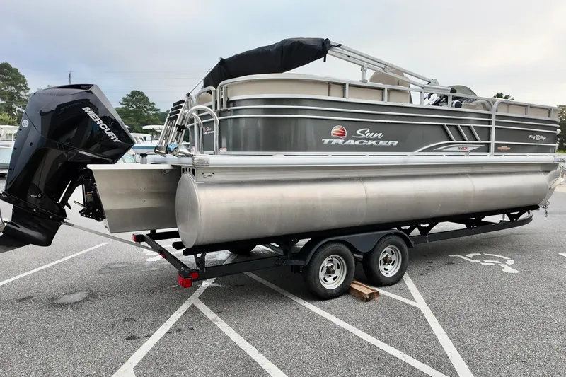 Slide: The Image of 2023 Sun Tracker Party Barge 22 DLX pontoon boat on trailer in parking lot. - 4