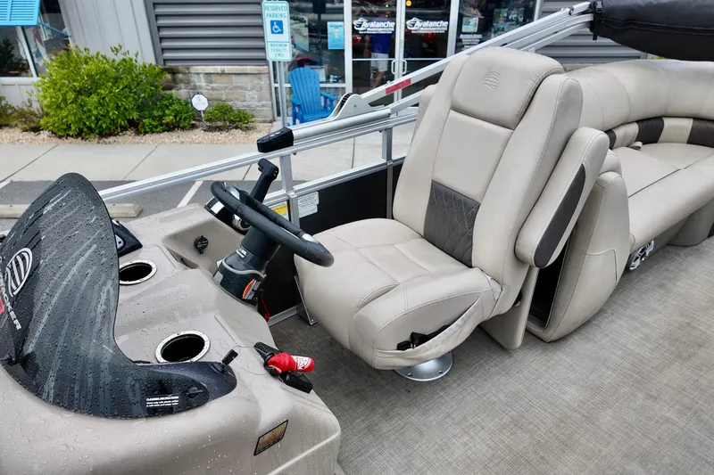 Slide: The Image of 2023 Sun Tracker Party Barge 22 DLX interior with steering wheel and seating. - 8