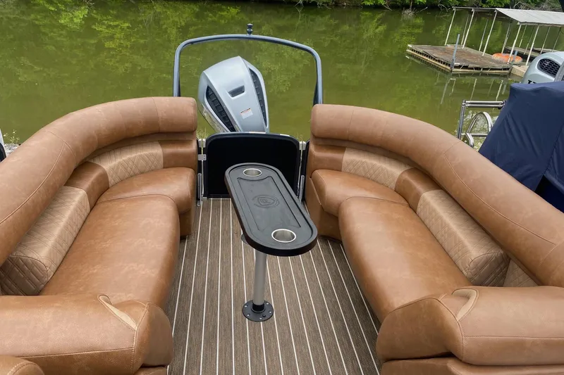 Slide: The Image of Luxurious seating on 2022 Premier 270 Intrigue RF pontoon boat, docked by a serene lake. - 3