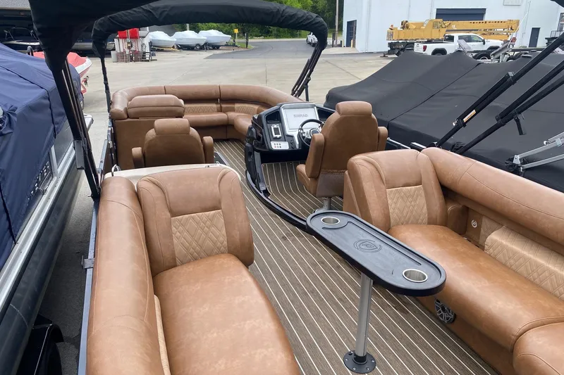 Slide: The Image of 2022 Premier 270 Intrigue RF pontoon boat with luxurious tan seating and modern dashboard. - 5