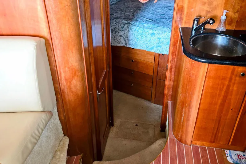Slide: The Image of Interior of 2003 Silverton 392 Motor Yacht with wood cabinetry and compact sink. - 11