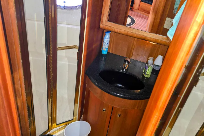 Slide: The Image of 2003 Silverton 392 Motor Yacht bathroom with sink, mirror, and shower. - 13
