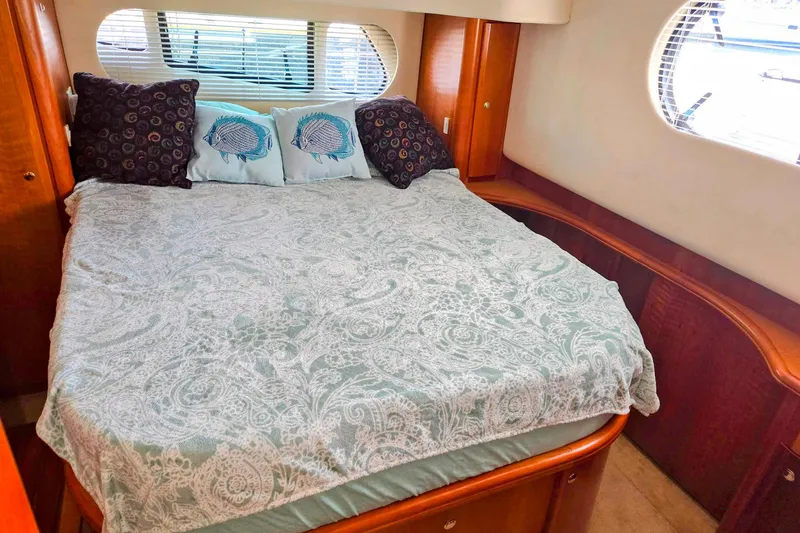 Slide: The Image of Luxurious bedroom interior of 2003 Silverton 392 Motor Yacht with elegant bedding and pillows. - 14