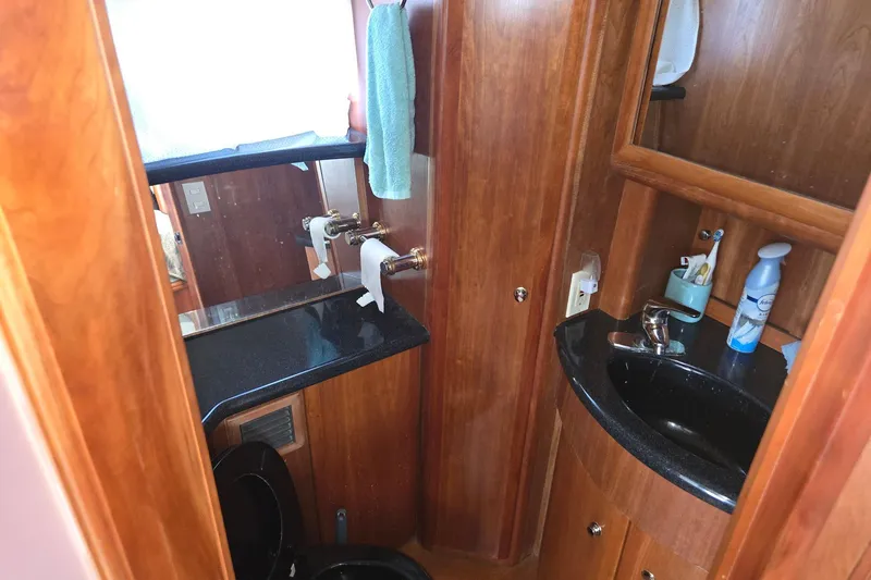 Slide: The Image of Luxurious 2003 Silverton 392 Motor Yacht bathroom with wood accents and modern amenities. - 15