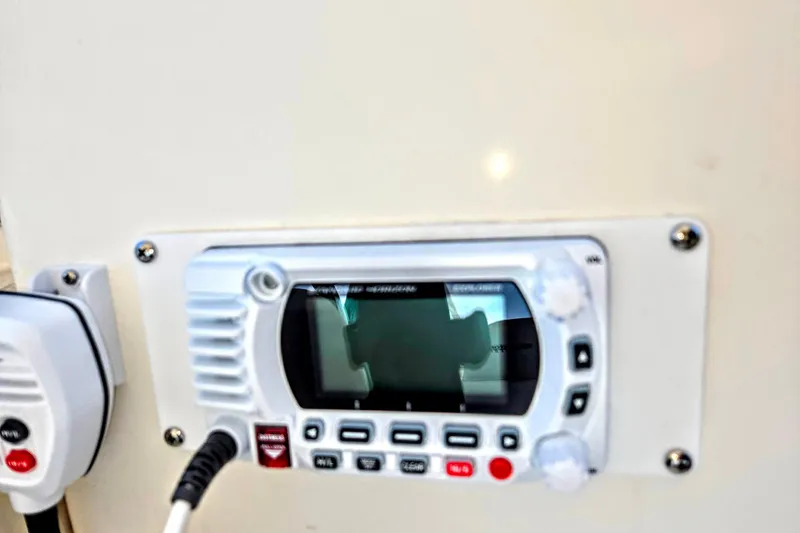 Slide: The Image of Close-up of a 2003 Silverton 392 Motor Yacht radio control panel. - 25