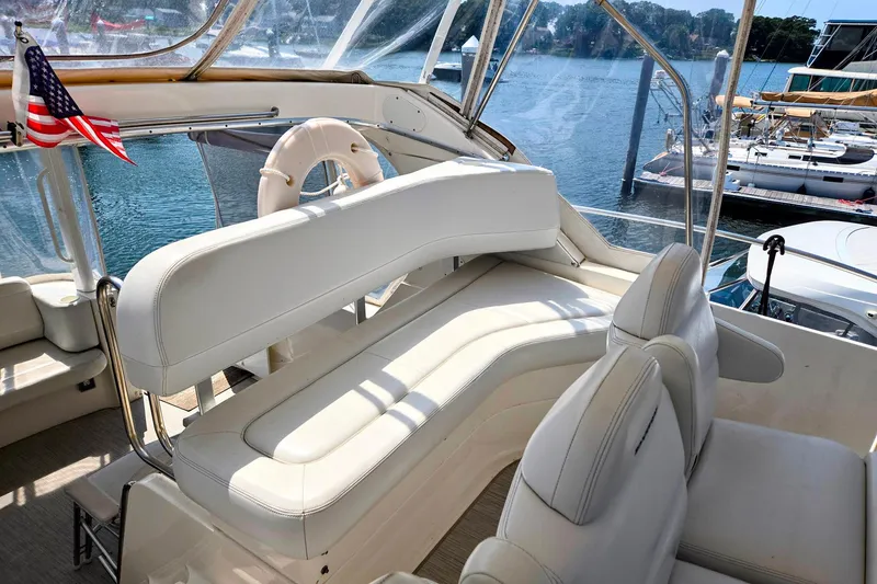 Slide: The Image of 2003 Silverton 392 Motor Yacht interior with white seating and American flag. - 27