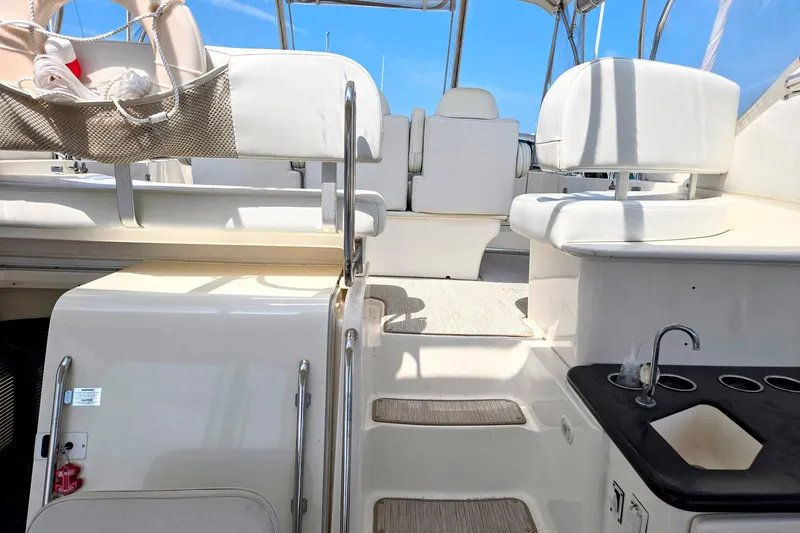 Slide: The Image of 2003 Silverton 392 Motor Yacht interior with seating and sink, under clear blue sky. - 28