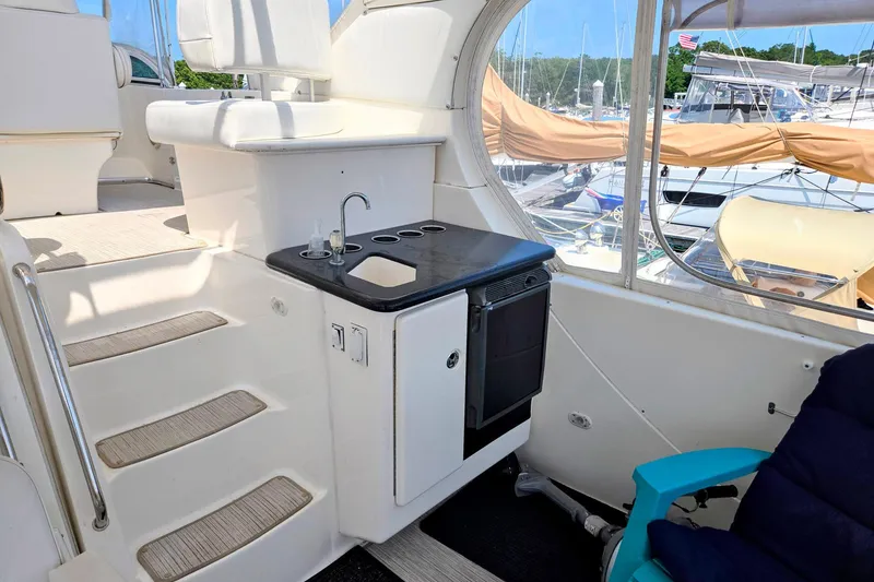 Slide: The Image of 2003 Silverton 392 Motor Yacht interior with kitchenette, sink, and seating area. - 29
