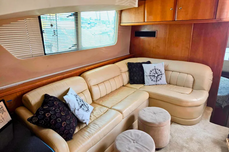 Slide: The Image of Luxurious 2003 Silverton 392 Motor Yacht interior with beige leather seating and nautical-themed pillows. - 3