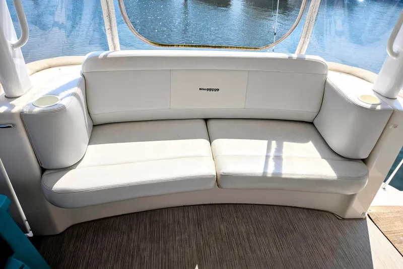Slide: The Image of 2003 Silverton 392 Motor Yacht interior with white cushioned seating and cup holders. - 31