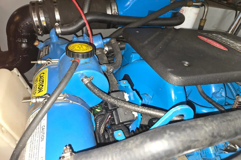 Slide: The Image of Engine compartment of a 2003 Silverton 392 Motor Yacht, featuring blue components and caution labels. - 36