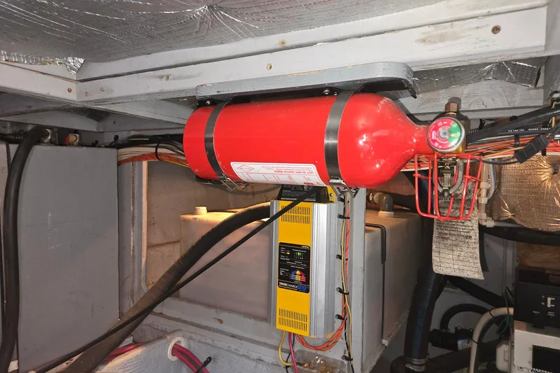 Slide: The Image of Engine room of 2003 Silverton 392 Motor Yacht with fire extinguisher and wiring. - 38