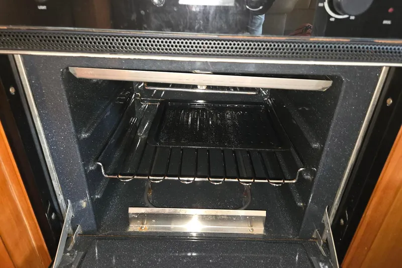 Slide: The Image of Open oven inside a 2003 Silverton 392 Motor Yacht kitchen. - 6