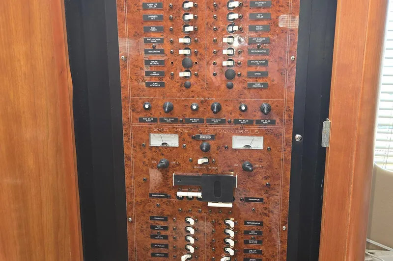 Slide: The Image of Control panel of a 2003 Silverton 392 Motor Yacht, featuring various switches and dials. - 9