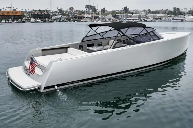 Slide: The Image of 2016 VanDutch CRUISER yacht on calm water, featuring sleek design and American flag. - 1