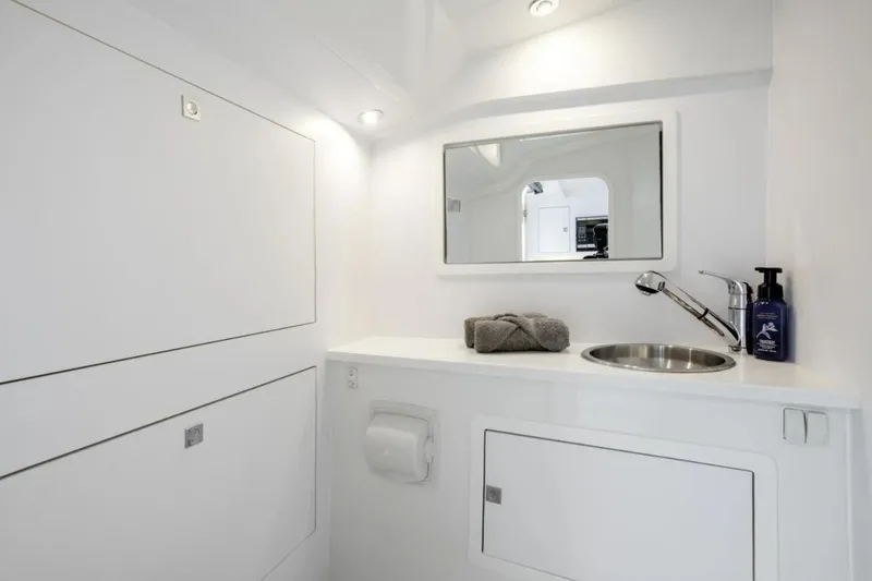 Slide: The Image of 2016 VanDutch CRUISER bathroom with modern sink, mirror, and storage cabinets. - 10
